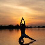 The golden light reflects off the water, symbolizing the awakening of the Divine Masculine energy